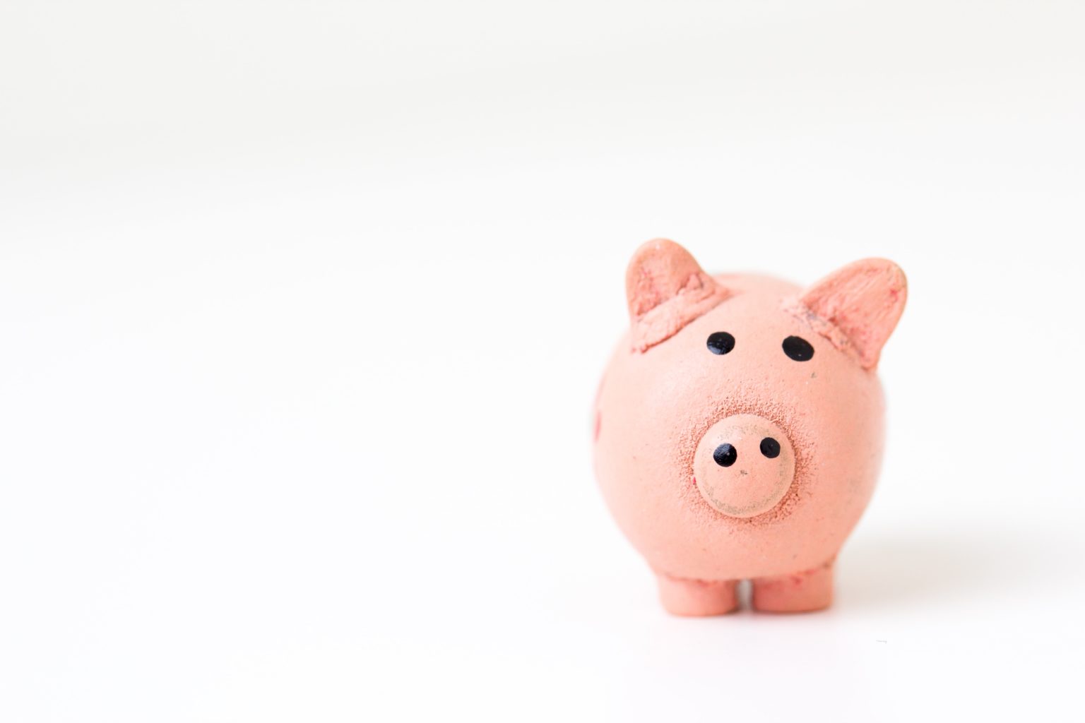 fabian-blank-pElSkGRA2NU-unsplash Pink piggy bank against white background