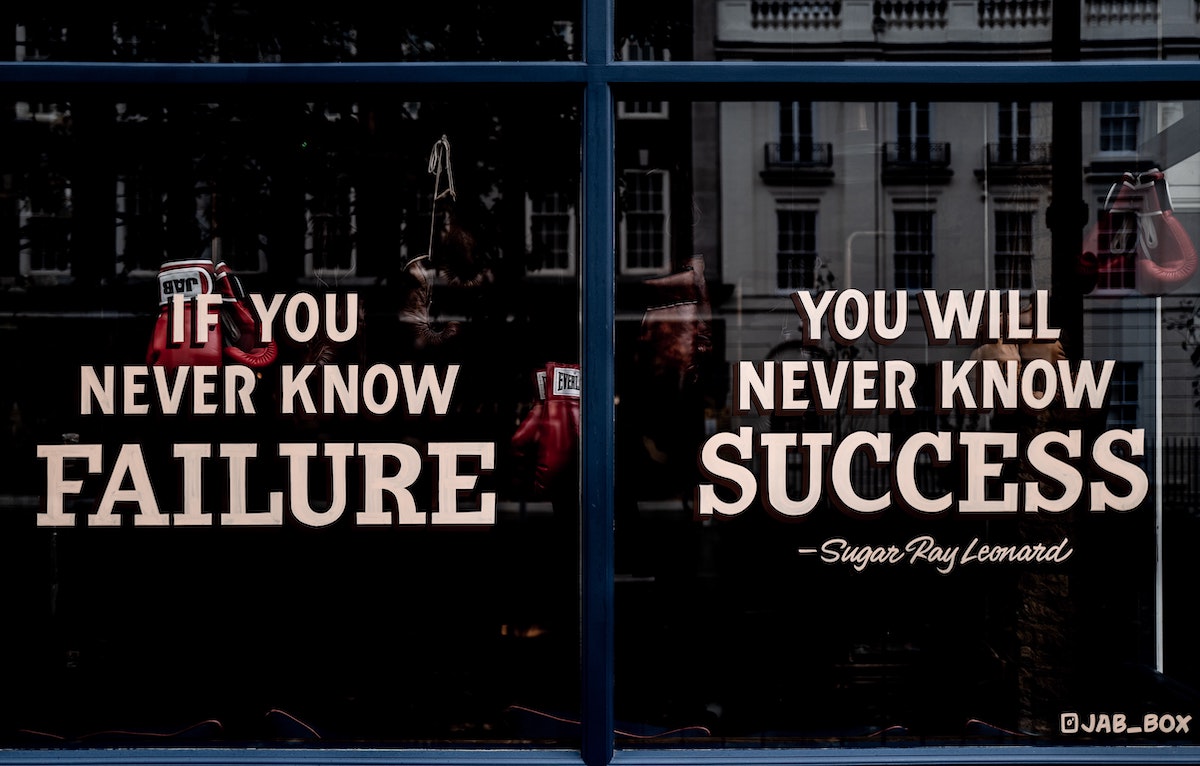 the-blowup-UN4PadDppAU-unsplash (1) Motivational sign in the window of a boxing gym.